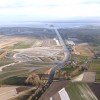 VUE AÉRIENNE DE LA GRANDE MARÉE DU SIÈCLE AU MONT SAINT MICHEL. LA NOUVELLE PASSERELLE ET LES RESTES DE L'ANCIENNE DIGUE, L'ANSE DE MOIDREY ET LES NOUVEAUX PARKING TOURISTIQUES, AU PETIT MATIN. LE MONT SAINT MICHEL REDEVENU UNE ÎLE A ATTIRÉ UN TRÈS GRAND NOMBRE DE TOURISTES A L'OCCASION D'UNE GRANDE MARÉE EXCEPTIONNELLE D'UN COEFFICIENT DE 118 LE MATIN ET 119 LE SOIR. LE MONT SAINT MICHEL, NORMANDIE, FRANCE. 22 MARS 2015.